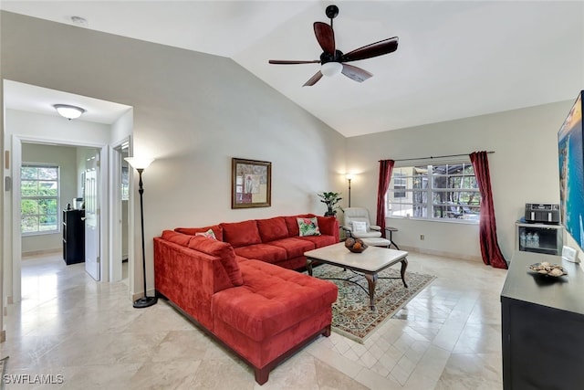 living room featuring ceiling fan, light tile patterned flooring, lofted ceiling, and a wealth of natural light