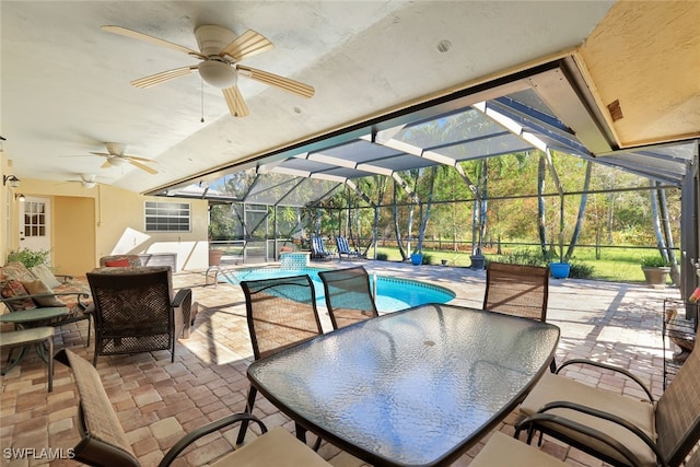 view of patio with glass enclosure and ceiling fan