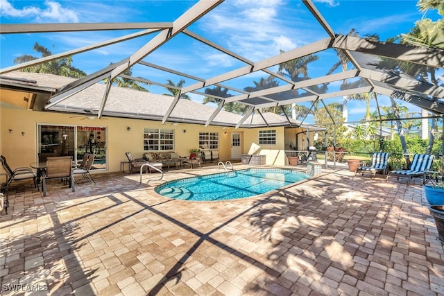 view of swimming pool featuring a lanai and a patio