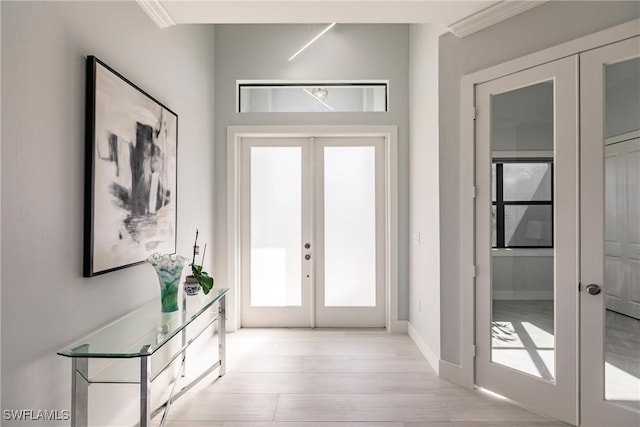 doorway to outside with french doors and ornamental molding