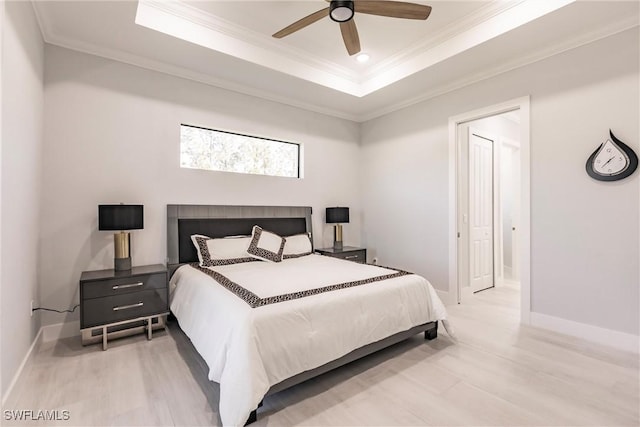 bedroom with a raised ceiling, ceiling fan, and ornamental molding