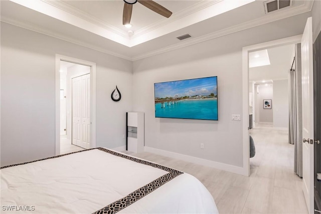 bedroom with ceiling fan, a closet, and ornamental molding