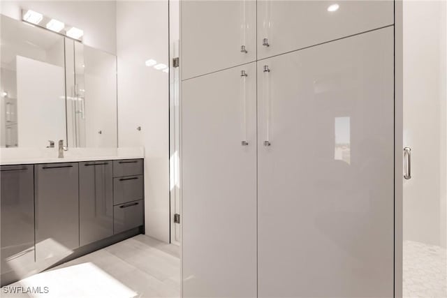 bathroom with vanity and a shower with shower door