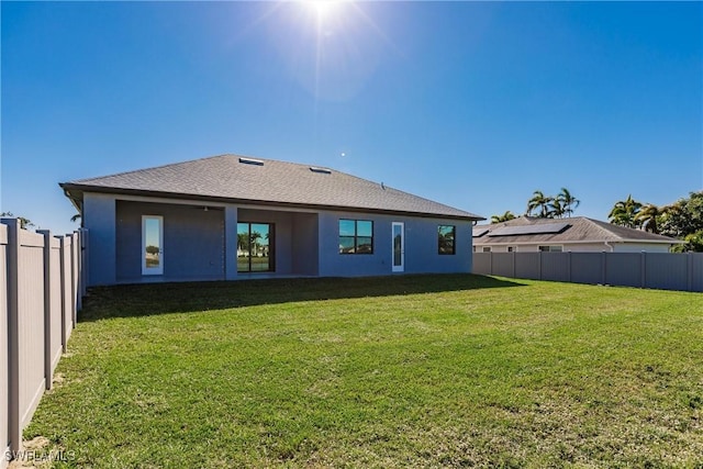 back of house with a lawn