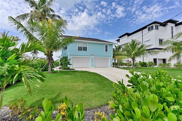 view of front of house with a garage and a front lawn