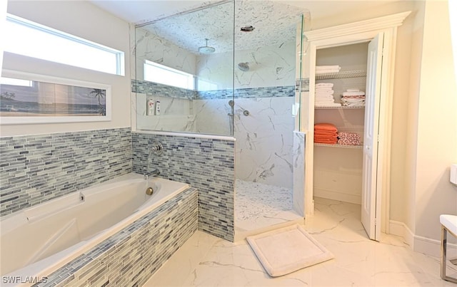 bathroom featuring independent shower and bath