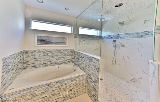 bathroom featuring separate shower and tub and tile walls