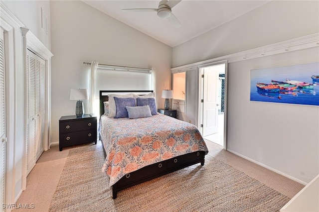 carpeted bedroom with a closet, high vaulted ceiling, and ceiling fan