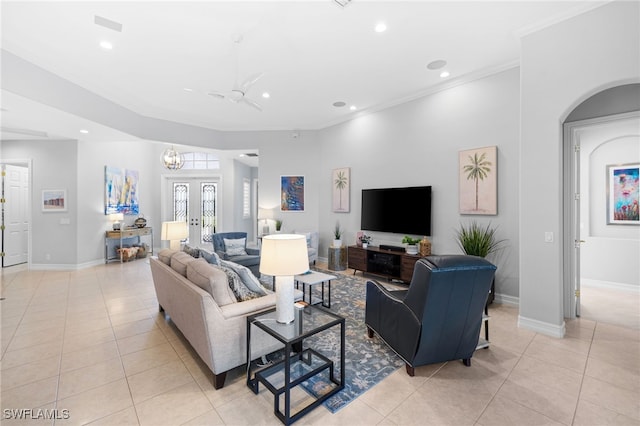 tiled living room featuring crown molding, french doors, and ceiling fan