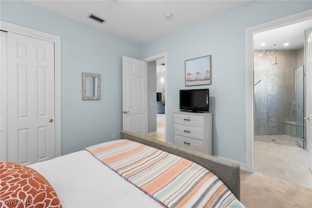 carpeted bedroom featuring ensuite bathroom and a closet