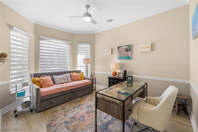 living room with crown molding, light hardwood / wood-style flooring, and ceiling fan