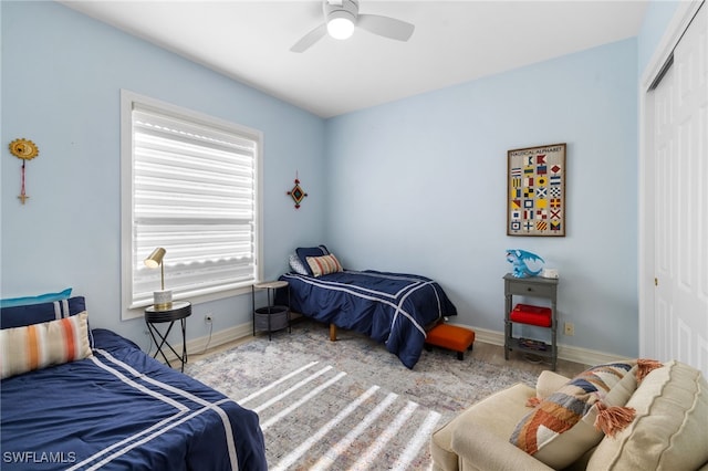 bedroom featuring light hardwood / wood-style floors, a closet, and ceiling fan