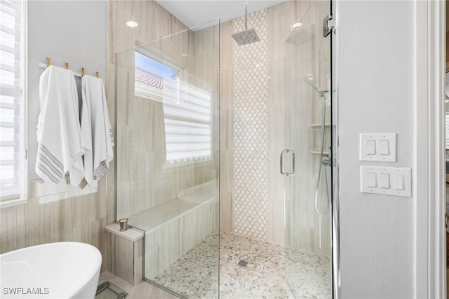 bathroom with shower with separate bathtub