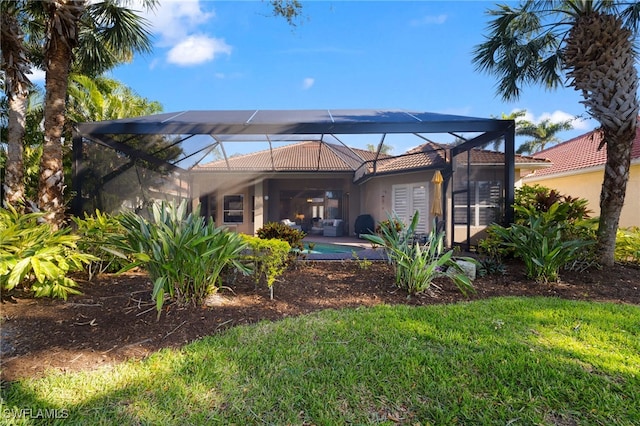 rear view of property with glass enclosure