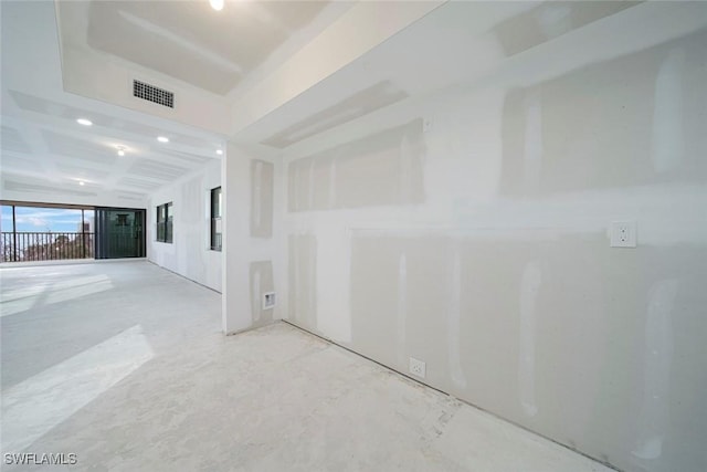 empty room with beam ceiling and coffered ceiling