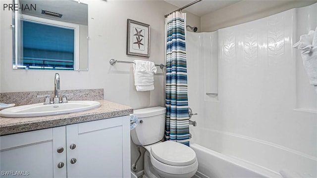 full bathroom featuring vanity, shower / bath combo, and toilet