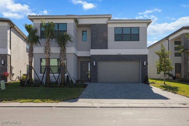 view of front of home with a front yard and a garage