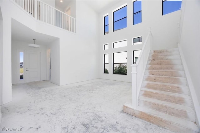 entryway featuring a towering ceiling