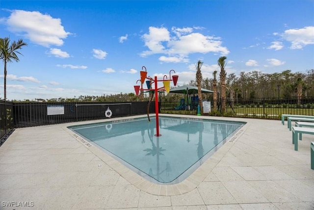 view of swimming pool with a playground