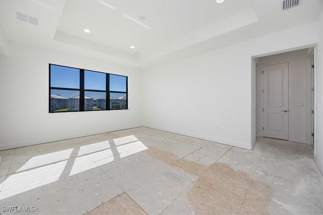 unfurnished room featuring a raised ceiling