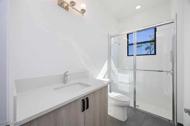 bathroom with vanity, an enclosed shower, and toilet