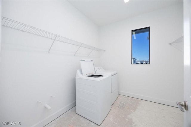 clothes washing area with separate washer and dryer