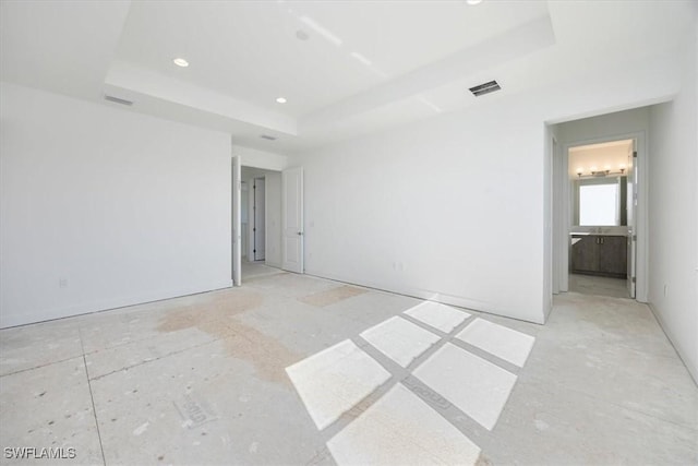 empty room featuring a raised ceiling