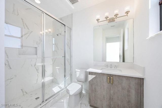 bathroom featuring vanity, an enclosed shower, plenty of natural light, and toilet