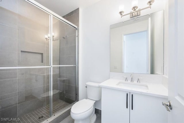 bathroom with vanity, toilet, and an enclosed shower