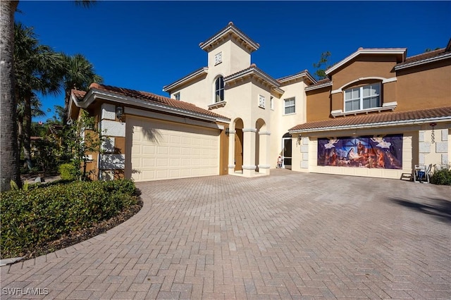 mediterranean / spanish-style home with a garage