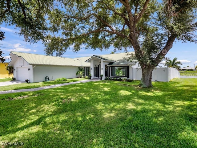 single story home featuring a garage and a front lawn