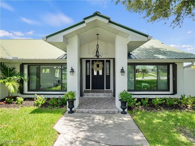 doorway to property featuring a lawn