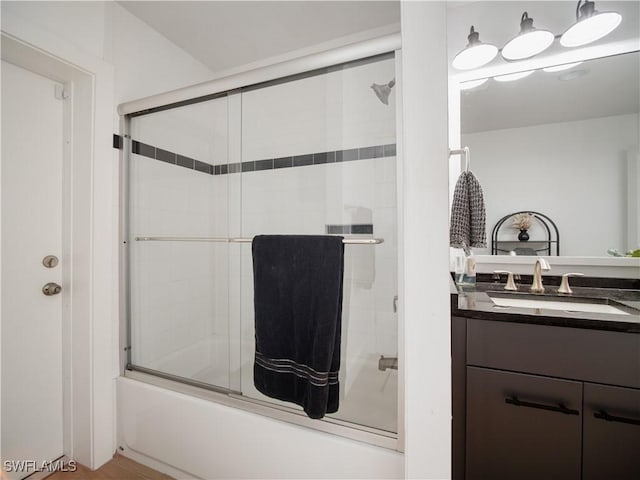 bathroom with vanity and combined bath / shower with glass door