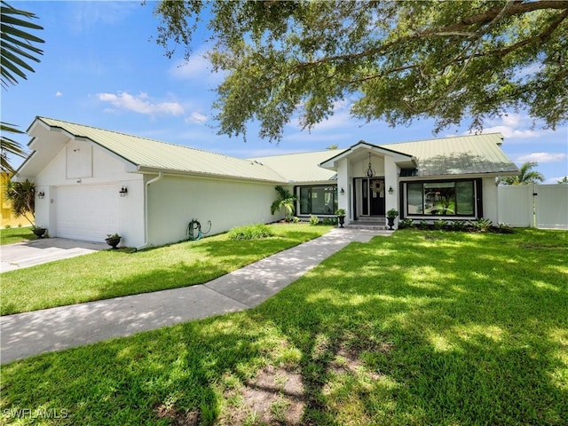 ranch-style house with a garage and a front lawn