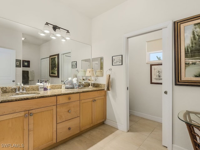 bathroom featuring tile patterned flooring and vanity