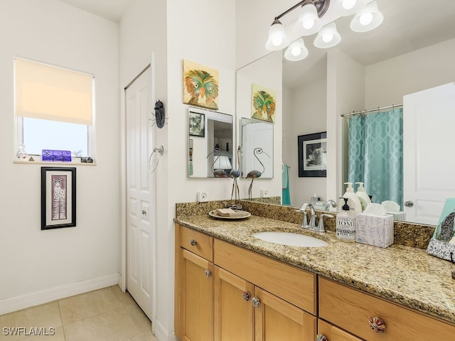 bathroom featuring tile patterned flooring and vanity