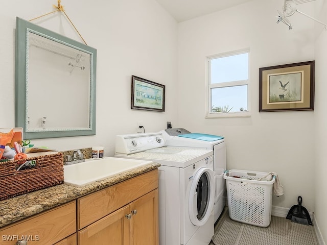 washroom with tile patterned flooring, cabinets, separate washer and dryer, and sink