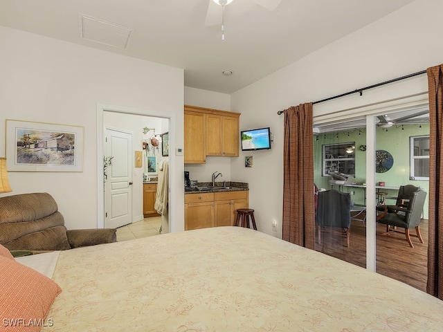 bedroom with ceiling fan, sink, and light hardwood / wood-style flooring