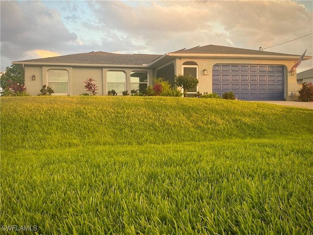 view of front of home featuring a garage and a front lawn