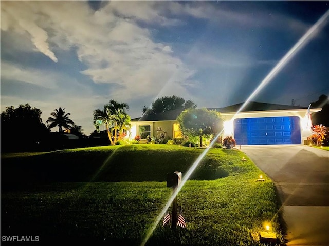 view of front of house with a garage and a front lawn