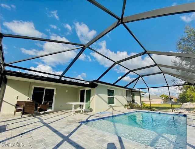 view of swimming pool with a patio and a lanai