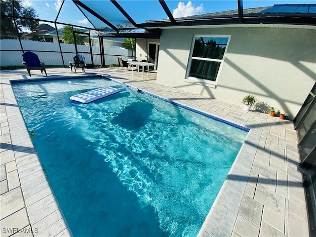 view of swimming pool with a lanai and a patio area