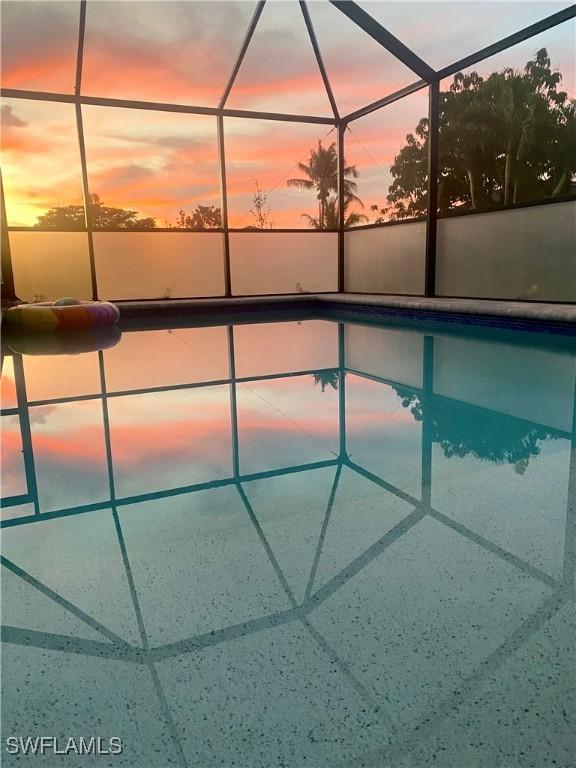 pool at dusk with glass enclosure