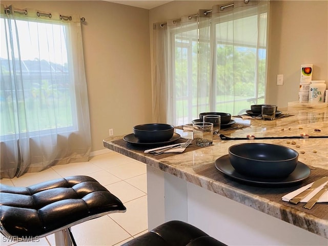 kitchen featuring light stone countertops and tile patterned floors