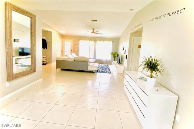 tiled living room featuring ceiling fan and lofted ceiling