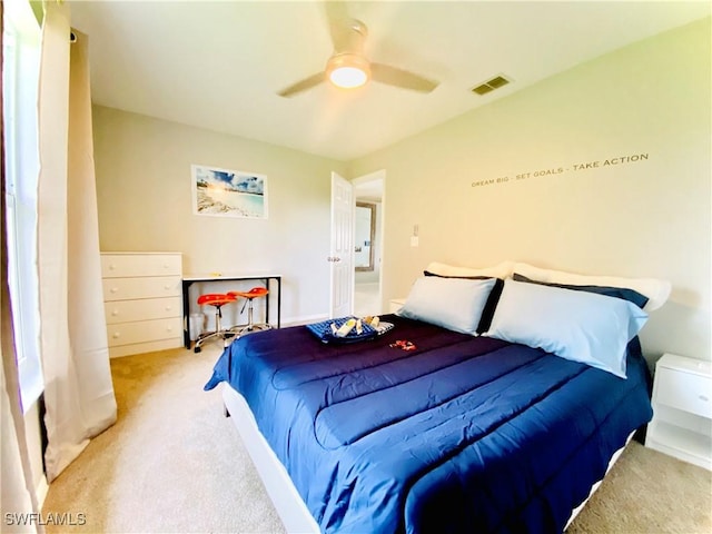 bedroom featuring light carpet and ceiling fan