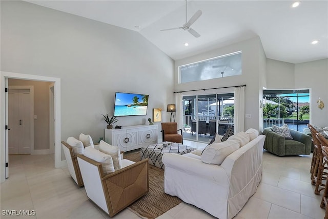 living room featuring light tile patterned floors, high vaulted ceiling, and ceiling fan