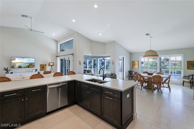 kitchen featuring stainless steel dishwasher, ceiling fan, sink, decorative light fixtures, and lofted ceiling