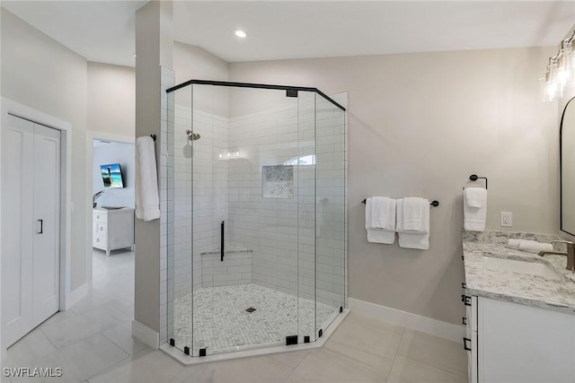 bathroom with tile patterned flooring, vanity, and a shower with door