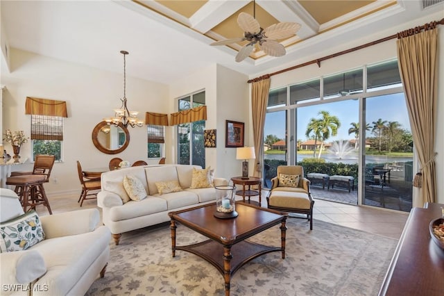 tiled living room featuring beam ceiling, a wealth of natural light, and ceiling fan with notable chandelier